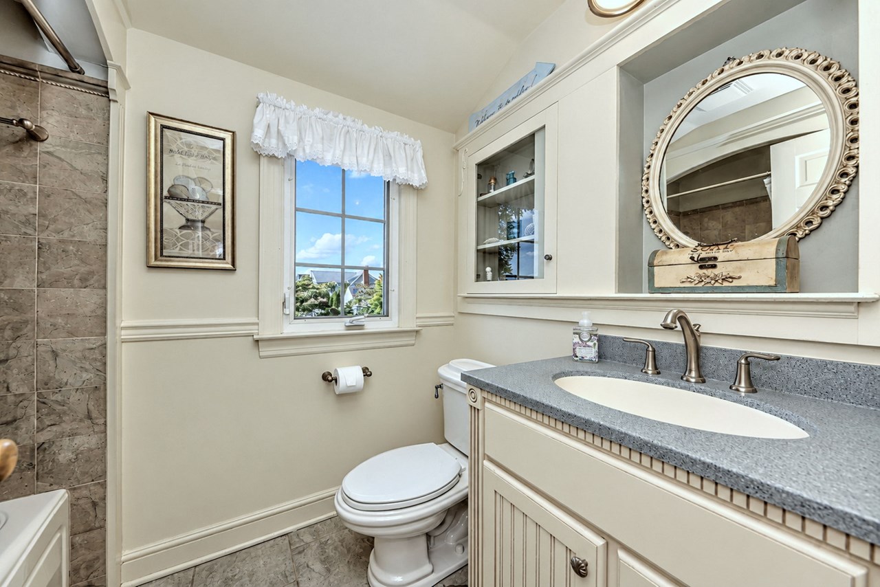 hall bath: beautiful tilework and built-in cabinetry.