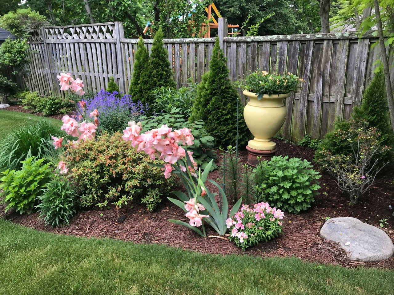 spacious patio surrounded by beautiful gardens - perfect for outdoor dining, entertaining, and relaxing.